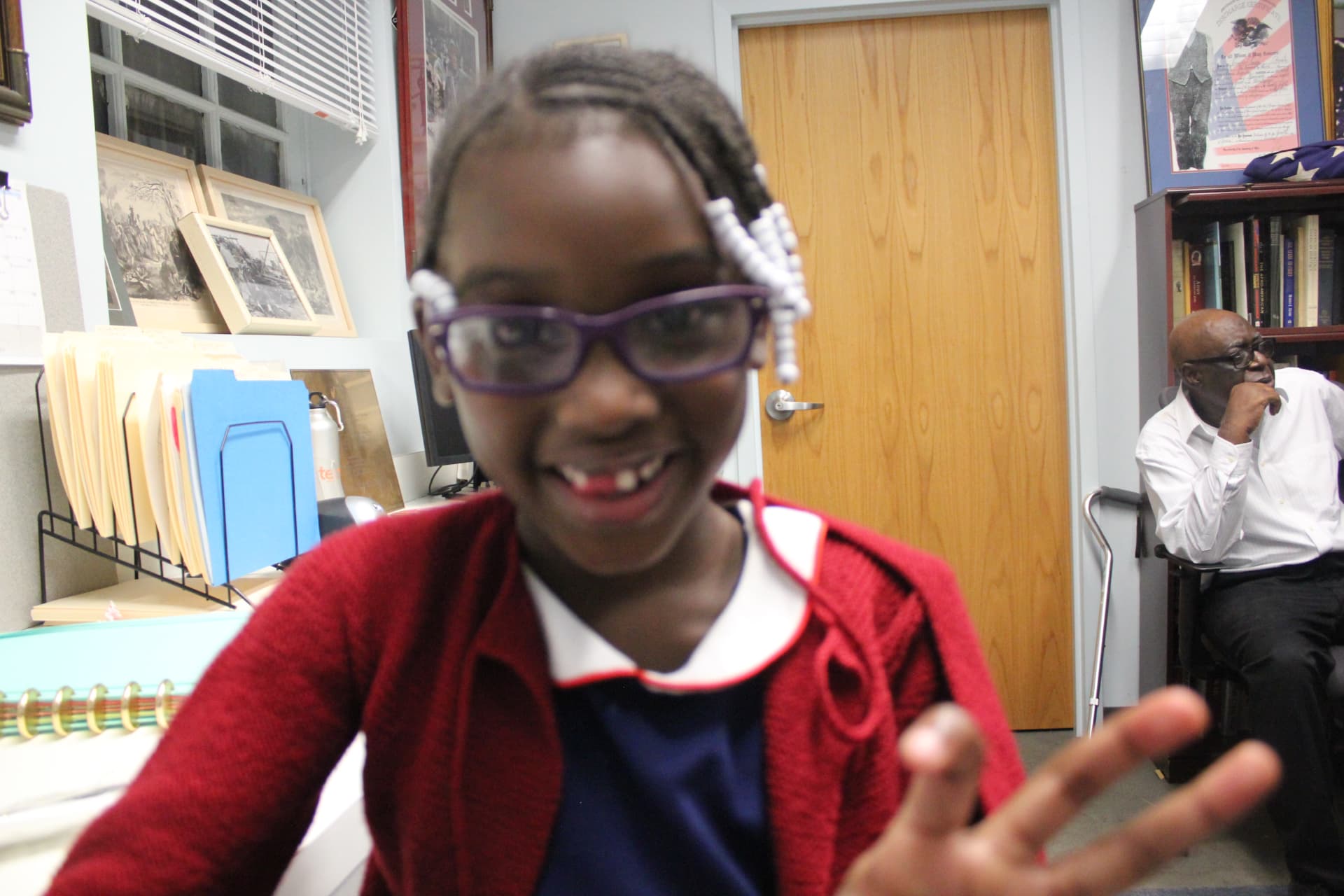 Joy, a young member of the Village, smiling